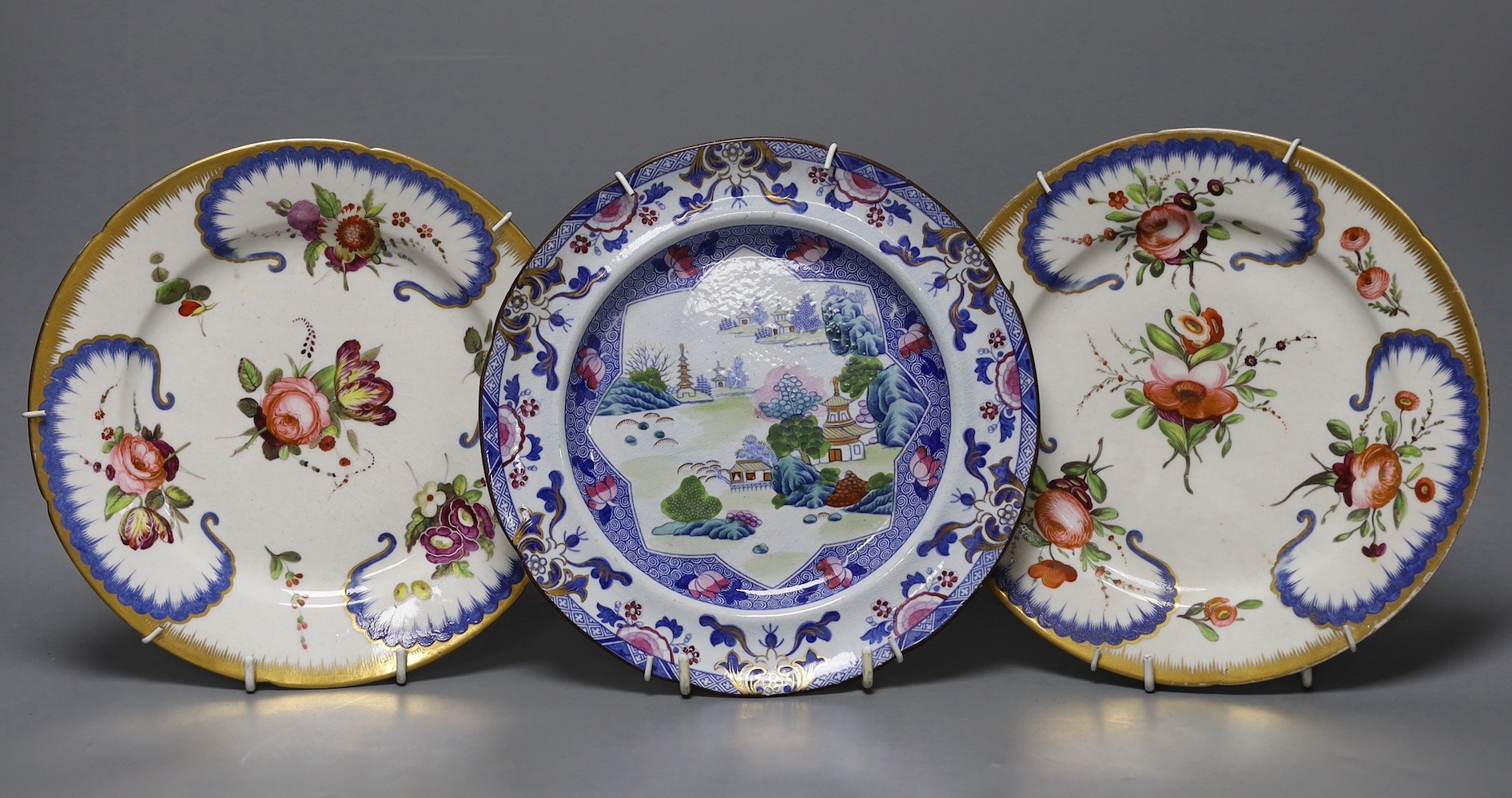 An stone china plate and a pair of Coalport floral plates, c.1815, Ironstone plate 22cms diameter